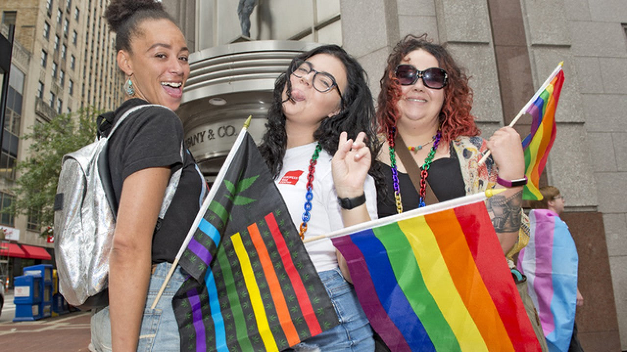 Group of Girls Holding Marijuana Rainbow USA Stick Flag