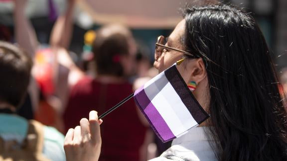 Woman Holding Asexual Stick Flag