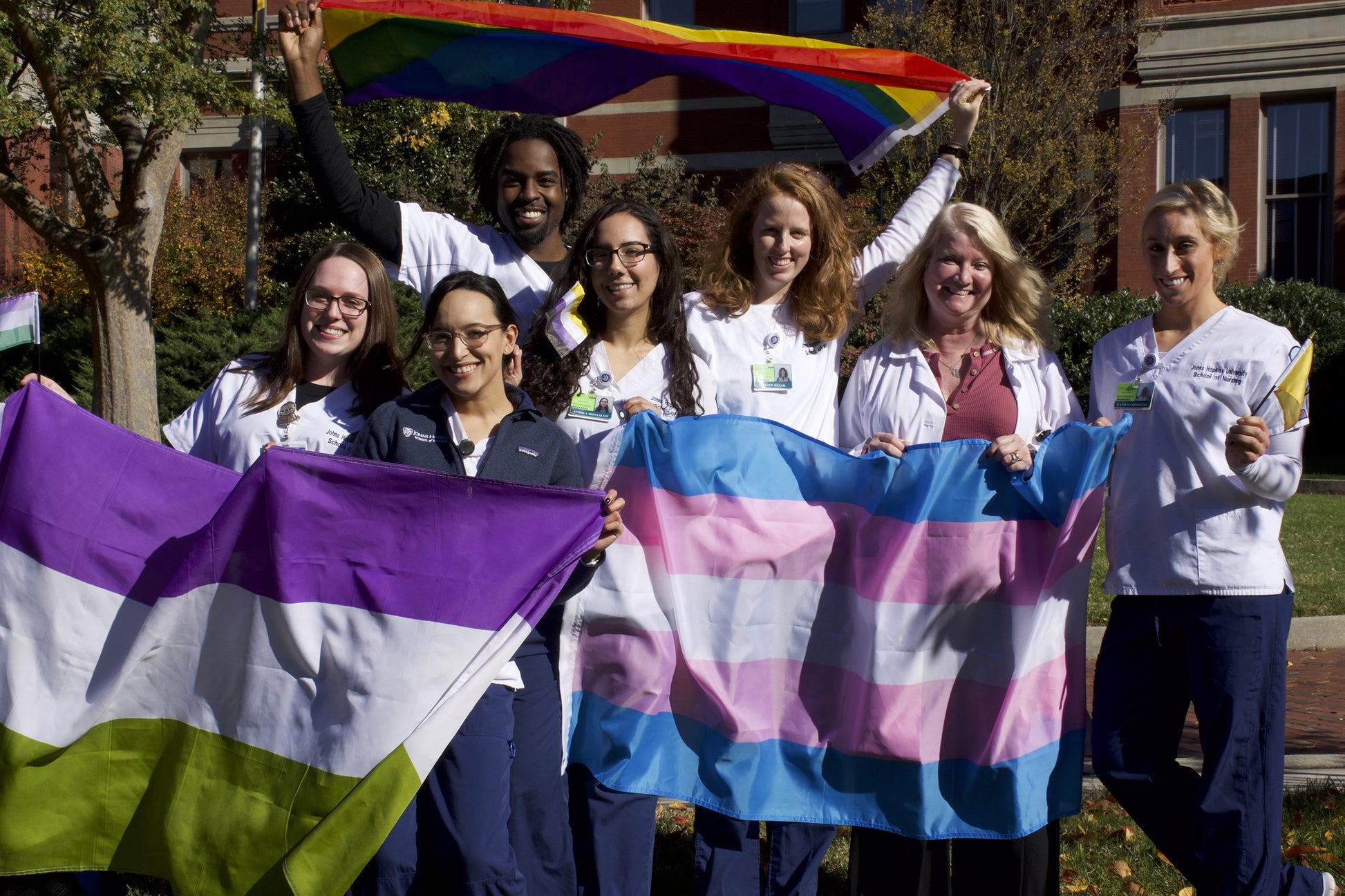 People Holding Genderqueer & Transgender Flags outdoors