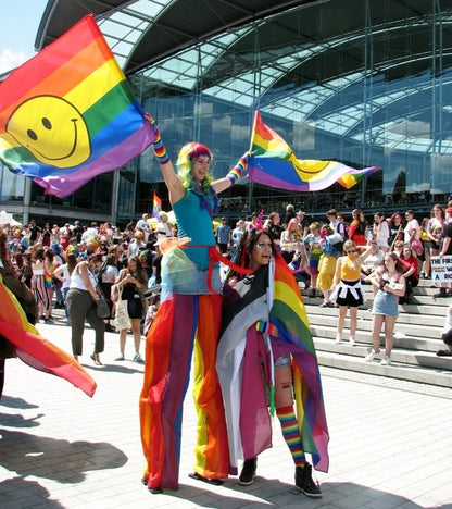 Rainbow Happy Face Flag 3x5ft Held by person on stilts